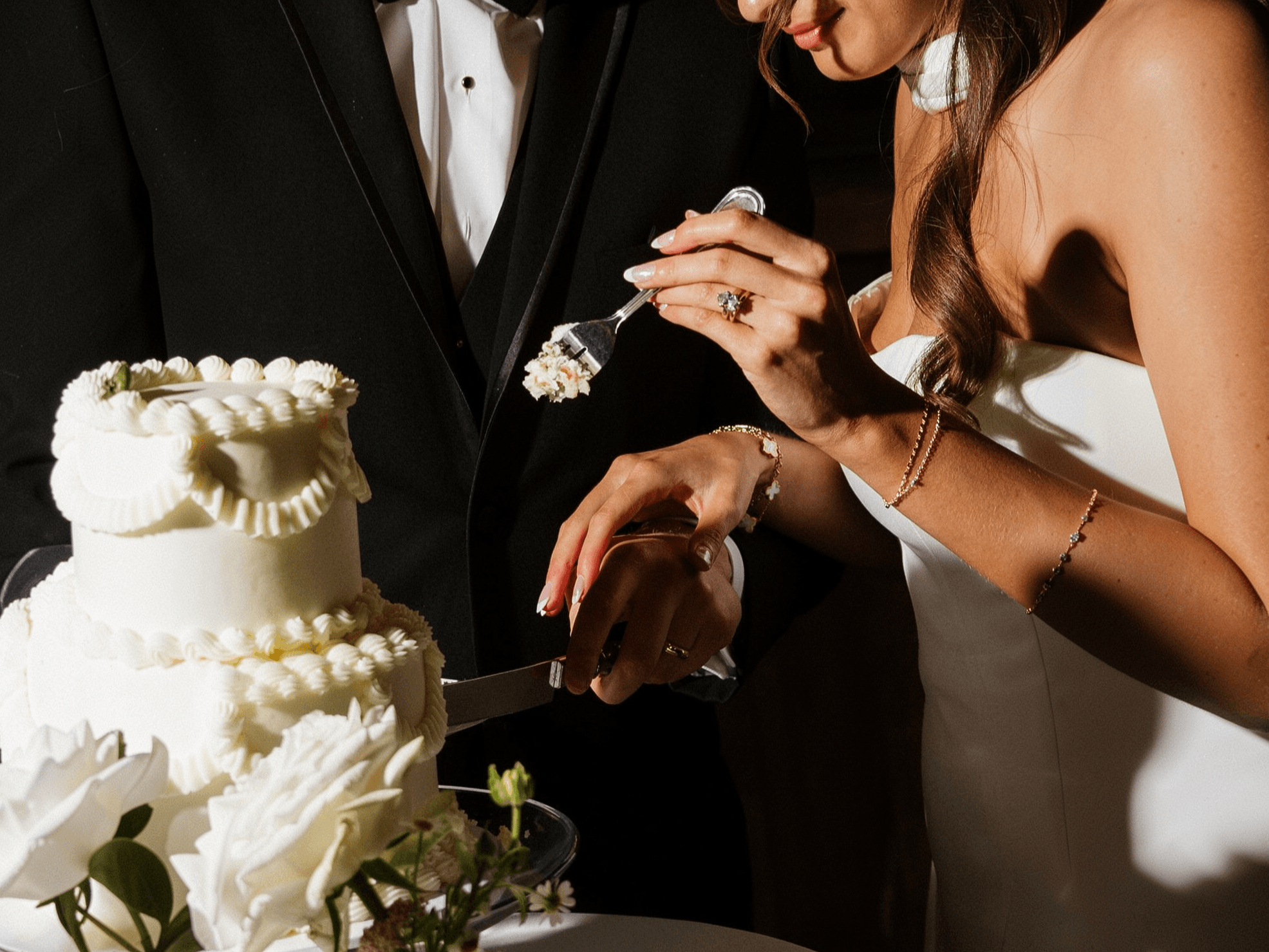 A bride and groom cutting their wedding cake
